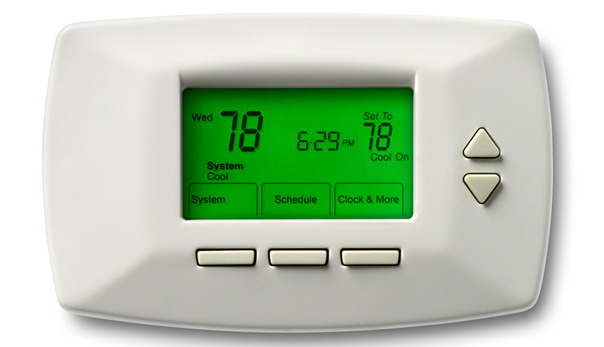 A digital thermostat with a green backlit screen displays the temperature set to 78 degrees. It shows Wednesday and 6:29 PM, with indicators for system mode, schedule, and additional settings. Three buttons are below the screen, and two arrows on the right.